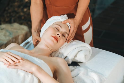 Attractive caucasian woman receive electrical facial treatment. Beautiful girl lies on spa bed while having medical treatment from professional doctor from medical spa center. Tranquility.