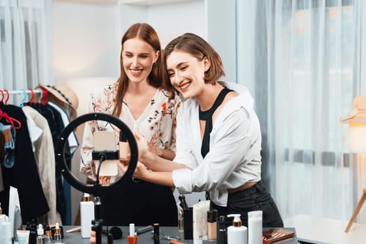 Woman influencer shoot live streaming vlog video review makeup utmost social media or blog. Happy young girl with cosmetics studio lighting for marketing recording session broadcasting online.