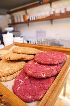 Many different cookies on trays display bakery cafe.