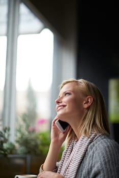 Phone call, thinking and woman in coffee shop happy for connection, social networking and talking. Restaurant, cafe and person on smartphone for conversation, communication and speak with beverage.