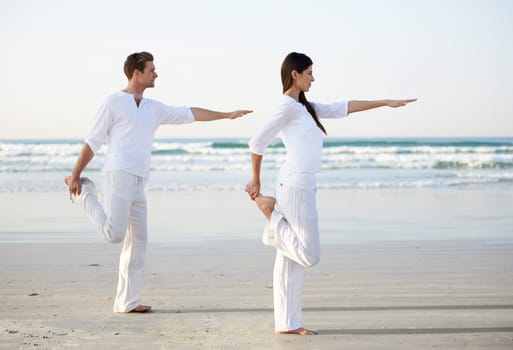 Couple, yoga and balance, fitness on beach for zen and wellness, travel and mindfulness with holistic healing. People outdoor, exercise and pose, workout together for bonding with ocean and nature.