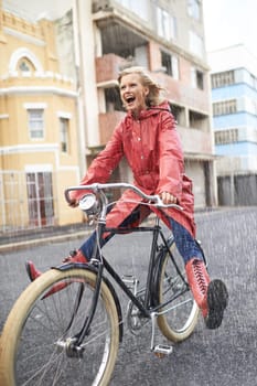 Woman, rain and city with vintage bicycle for eco friendly transportation with scream, happy and freedom. Girl, person and retro bike on street, road or travel with sustainability in Cape Town metro.
