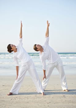 Stretching, yoga and couple on beach in morning for fitness, exercise and workout for performance. Nature, love and man and woman by ocean for pilates, wellness and healthy body outdoors together.