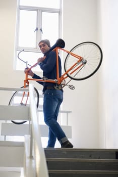 Bicycle, stairs and man carrying bike for green and eco friendly transportation for travel. Staircase, carry and cyclist with apartment complex, take up and journey of walking steps in building.