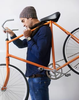Man, studio and bicycle for sustainability, health and transportation on white background. Hipster cyclist, carbon neutral or eco friendly travel for environmental commute and fitness or exercise.