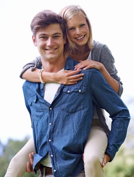 Portrait, smile and piggyback with couple in countryside together for love, romance or bonding. Happy, date or hugging with young man carrying woman outdoor in nature for hiking or adventure.