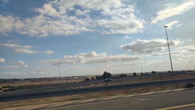 evening landscape, desert road, blue sky and earth, white clouds. High quality photo