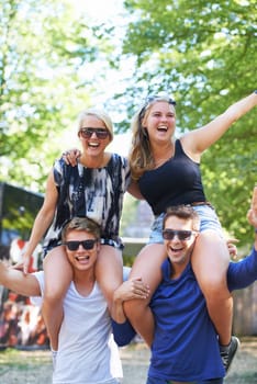 Friends, happy and excited celebration in park together for cheerful, fun or enjoyment outdoors in nature. Group of people, smile and crazy in summer for camping, festival or social event in forest.