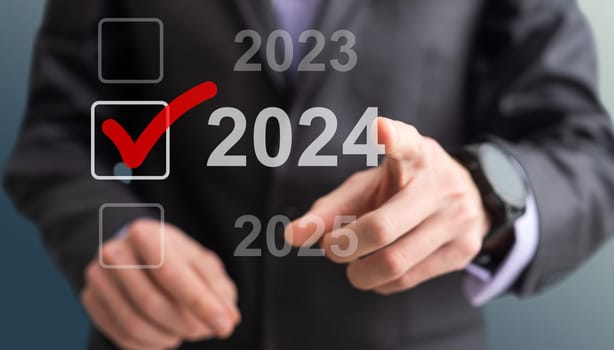 Businessman pressing virtual button New 2024 Year. High quality photo