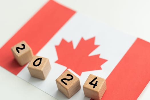2024, Canada, Canada flag with date block, Concept, Important events for Canada in the new year, election, economy, social activities, central bank, Canada foreign policy. High quality photo