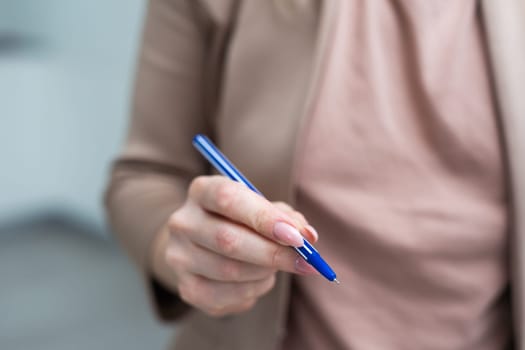 Using a hand hold the pen for writing. High quality photo