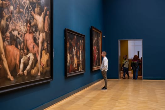 Copenhagen, Denmark - January 20, 2024: A visitor looking at paintings inside the National Gallery of Denmark