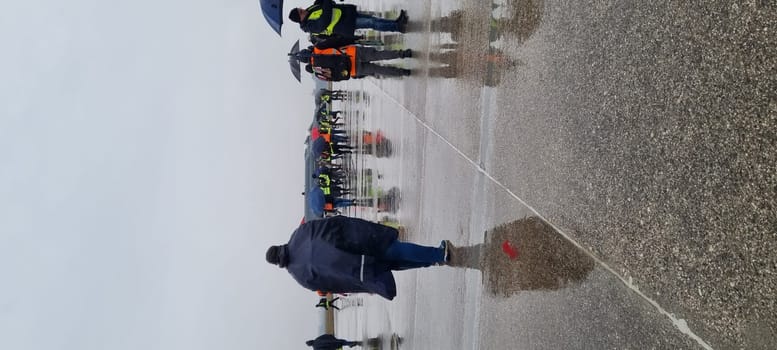 Combat fighter jet parked under the rain, surrounded by photographers, blending military prowess with artistic interest. McDonnell Douglas F-4 Phantom II of Turkish Air Force Vertical Image.