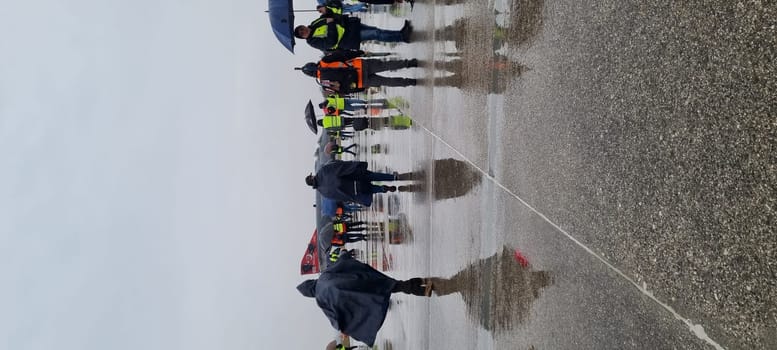 Combat fighter jet parked under the rain, surrounded by photographers, blending military prowess with artistic interest. McDonnell Douglas F-4 Phantom II of Turkish Air Force Vertical Image.