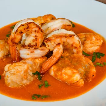 Recipe for Armorican-style monkfish tail, prawns, flambees with cognac, High quality photo