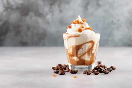 A glass of caramel latte topped with whipped cream and caramel pieces surrounded by coffee beans.