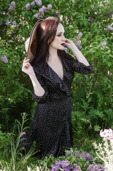 A fashionable girl with dark hair, a spring portrait in lilac tones in summer. Bright professional makeup