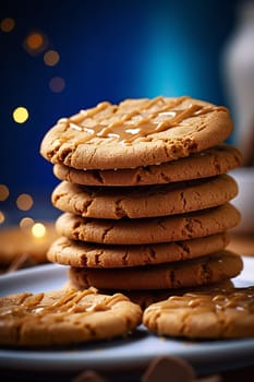 Stack of peanut butter cookies with caramel on top.