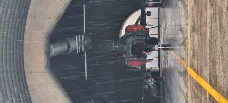 Vertical photo of a NATO fighter jet inside the hangar, prepped for takeoff, featuring copy space, illustrating the aircraft's readiness and the strategic anticipation of its mission.