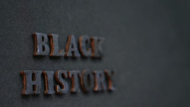 Inscription text Black History Month on dark isolated background close up. Celebrating the African American Conceptual Holiday for Equality