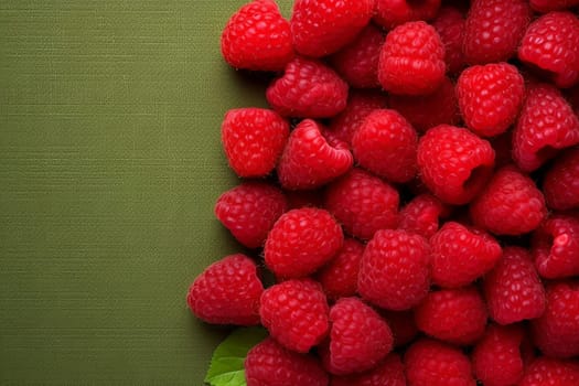 Fresh raspberries on a green textured background.