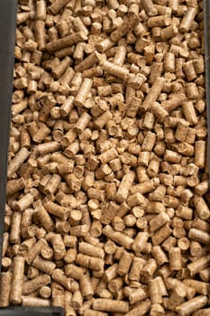 Wooden pet bedding vertical background. Wood pellets texture