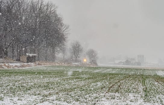 In a Snow Storm a Steam Passenger Train is Approaching, Traveling Thru the Countryside, on a Winters Day