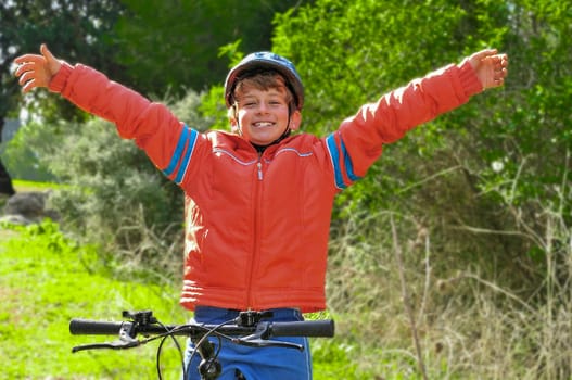 A boy rejoices after winning a bicycle race at a school competition