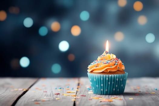 A lit birthday candle on a cupcake with sprinkles against a bokeh background.