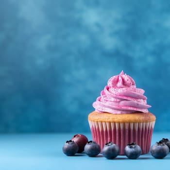 A single cupcake with blue icing