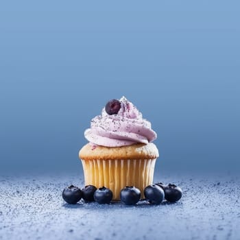 A purple frosted cupcake surrounded by blueberries on a blue background.