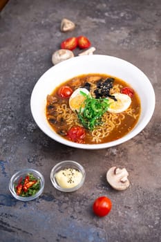 A steaming bowl of traditional Japanese ramen, filled with savory broth, springy noodles, and topped with an assortment of fresh vegetables and tender slices of pork.