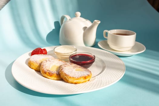 Enjoy a wholesome breakfast with fluffy cottage cheese pancakes topped with jam, fresh strawberries, and a dollop of sour cream. Energize your day with this delicious and nutritious meal.