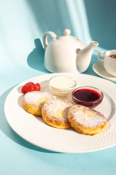 Enjoy a wholesome breakfast with fluffy cottage cheese pancakes topped with jam, fresh strawberries, and a dollop of sour cream. Energize your day with this delicious and nutritious meal.