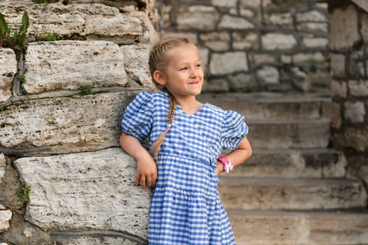 A six-year-old girl laughs outside in summer