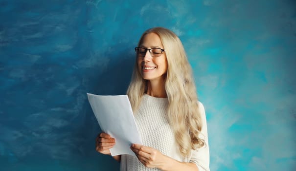 Professional caucasian middle aged woman employee in eyeglasses while working with paper document at home or office