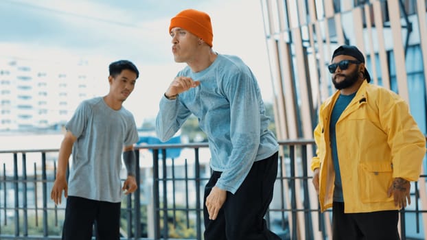 Hip hop team dance break dance while multicultural friend surrounded and clapping hands to cheer or encourage his friend to dance. Active and energetic street dance. Outdoor sport 2024. Endeavor.