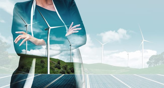 Double exposure graphic of business people working over wind turbine farm and green renewable energy worker interface. Concept of sustainability development by alternative energy. uds