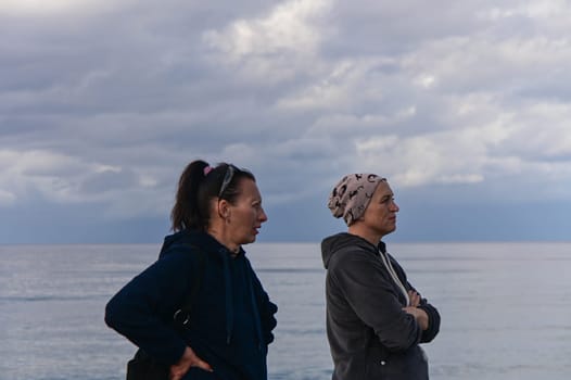 portrait of two women on the shores of the Mediterranean sea in winter