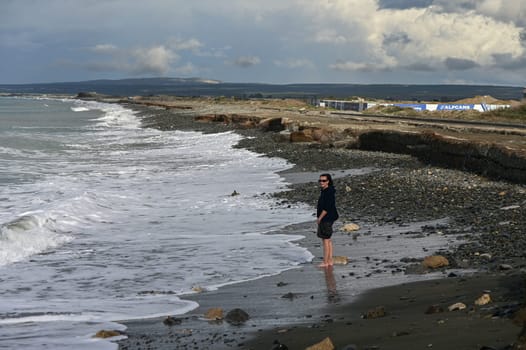 woman walks barefoot on the water in the Mediterranean Sea in Cyprus in winter 2023 2