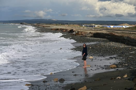 woman walks barefoot on the water in the Mediterranean Sea in Cyprus in winter 2023 1