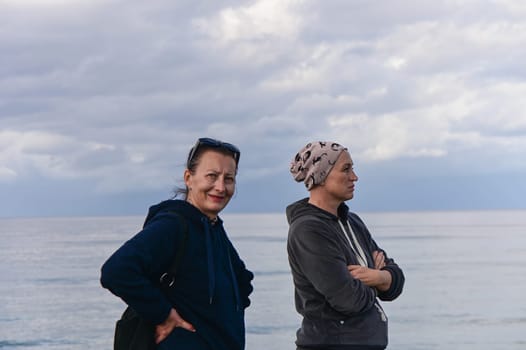 portrait of two women on the shores of the Mediterranean sea in winter 2