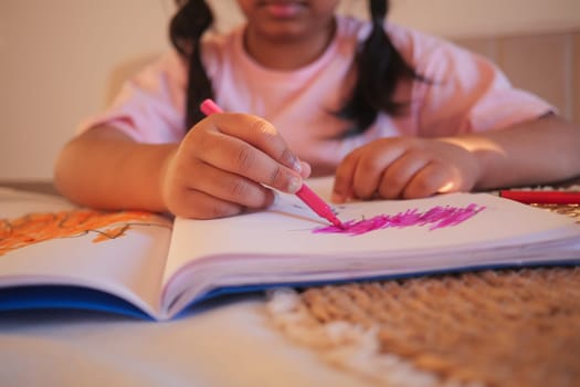 child girl drawing on paper sitting on floor .