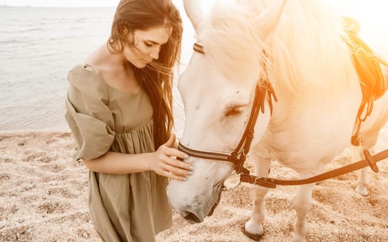 A white horse and a woman in a dress stand on a beach, with the sky and sea creating a picturesque backdrop for the scene