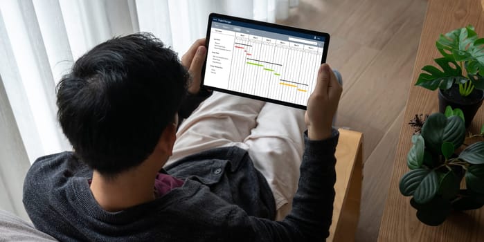 Project planning software for modish business project management on the computer screen showing timeline chart of the team project