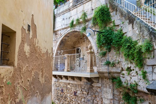 Attractive balcony in a stone house in the Ragusa Ibla city in Sicily, Italy