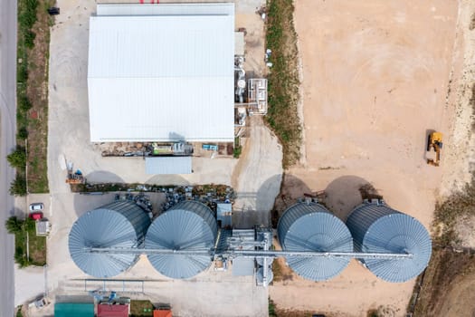 Modern agricultural Silo from above. Set of storage tanks cultivated agricultural crops processing plant. 