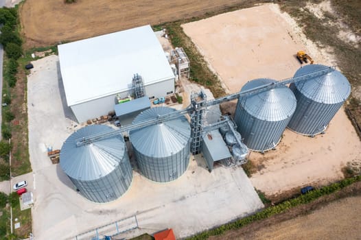 Modern agricultural Silo from above. Set of storage tanks cultivated agricultural crops processing plant. 