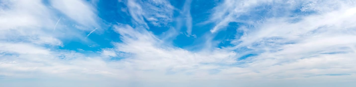 Panoramic view of blue sky with fluffy clouds 