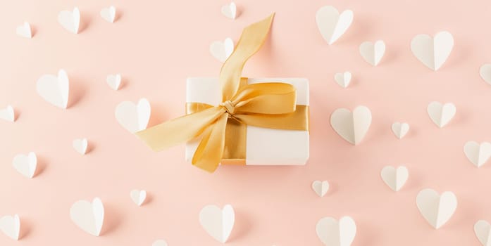 Top view flat lay of paper hearts and gift box on pastel pink background surprise your loved with space for text, birthday greeting, web design banner holiday, Happy Valentine Day Background
